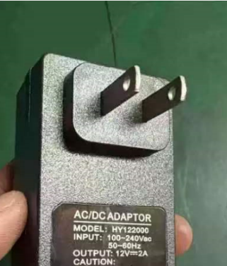 Close-up view of the AC/DC power adapter for the Lumina intelligent sleep and massage pillow